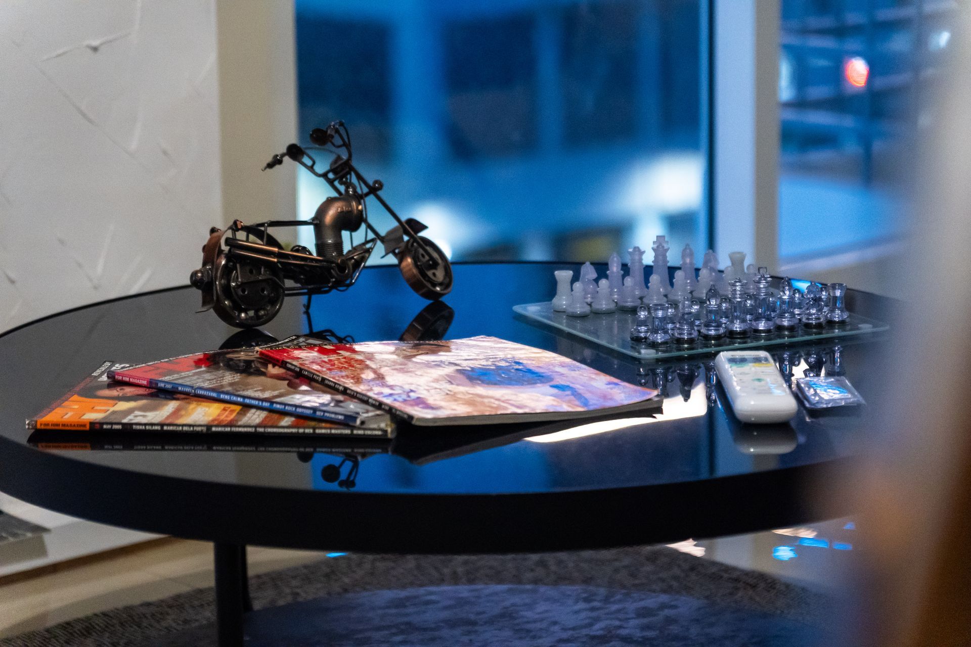 Coffee Table, magazines, crystal chess set & motorcycle sculpture - Captain's Quarters at Bayshore Luxe by Prime, Manila