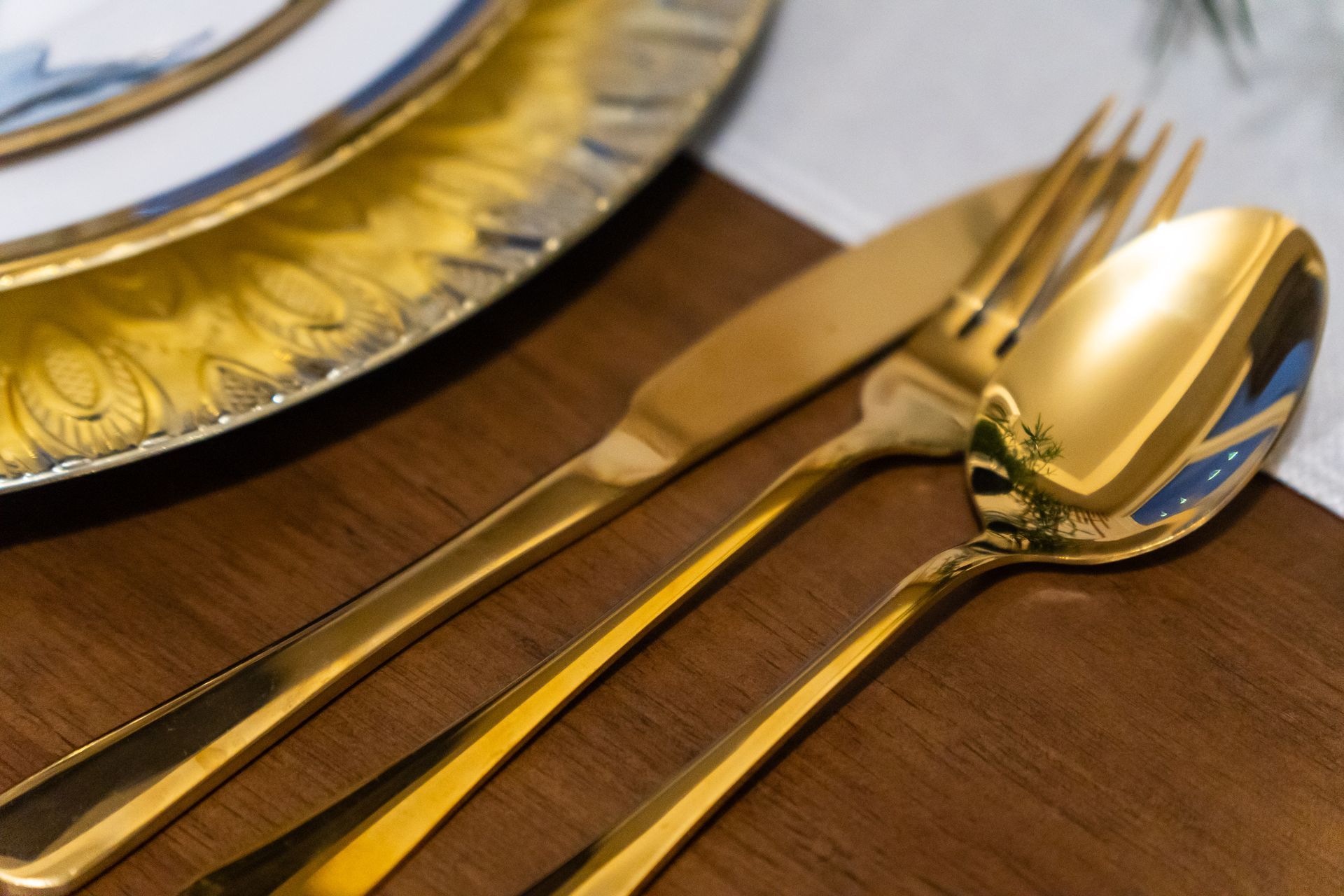 Gold cutlery set on a dining table