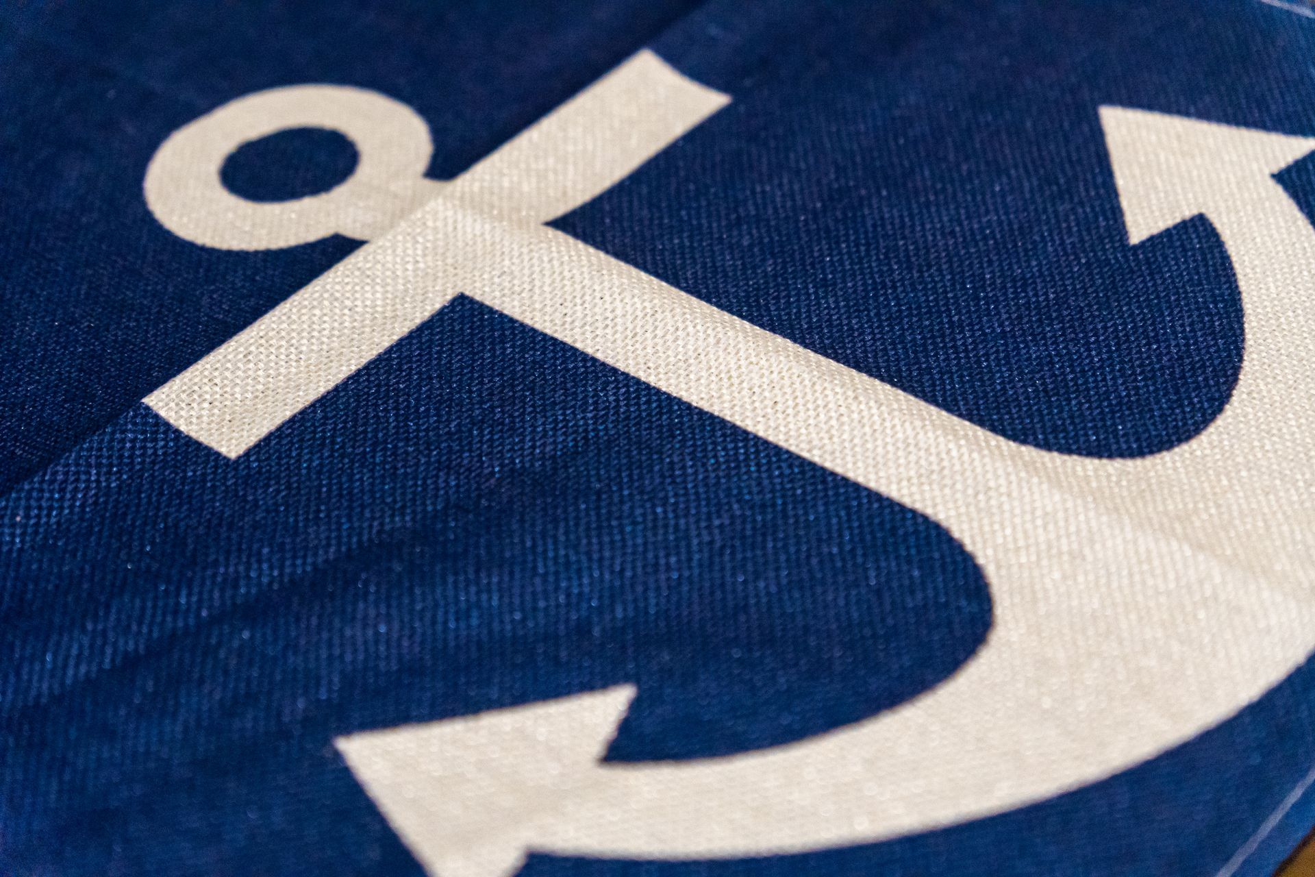 A blue cloth with a white anchor on it
