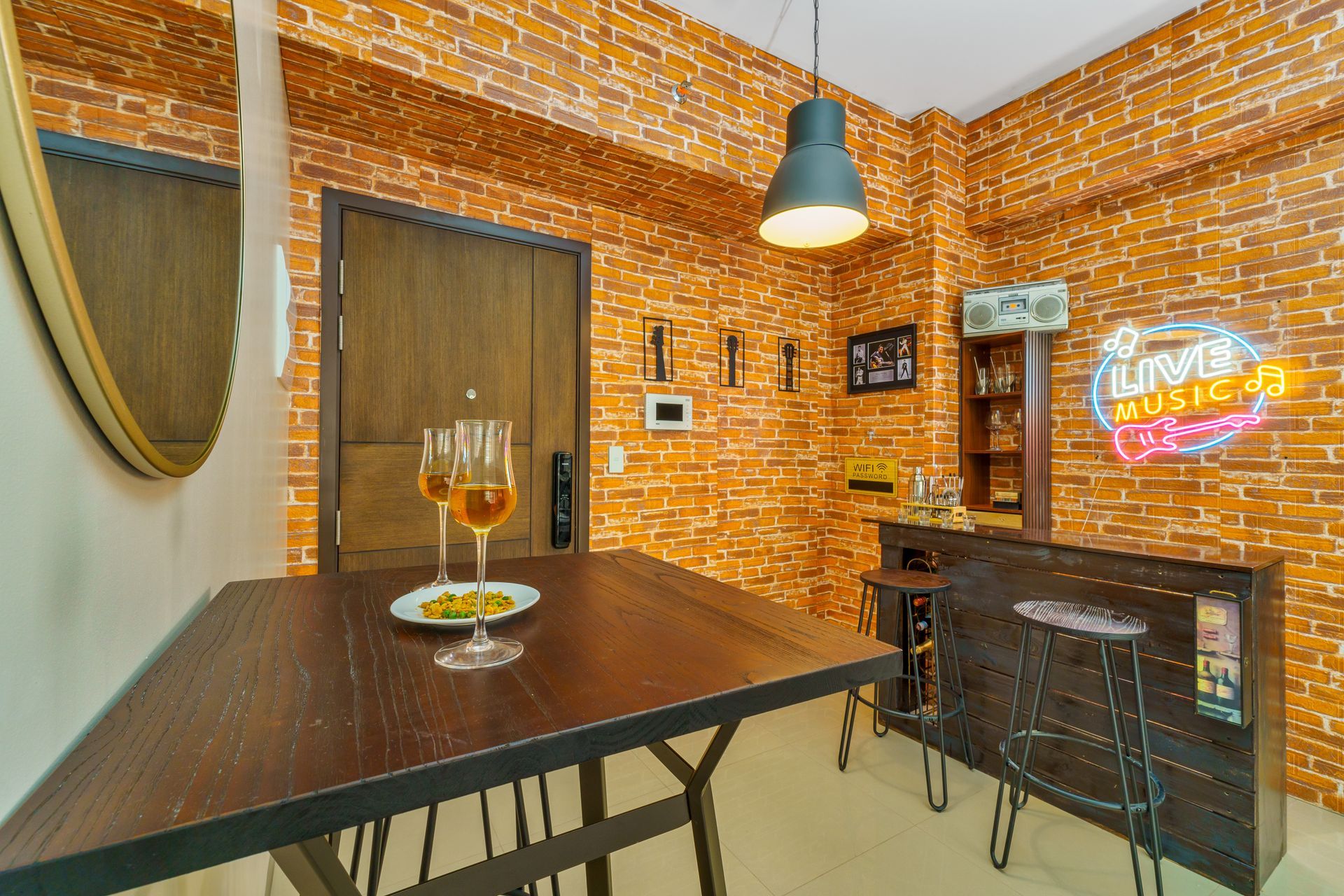 Stand up bar and stand up bar table, with wrought iron stools and a faux brick wall effect behind