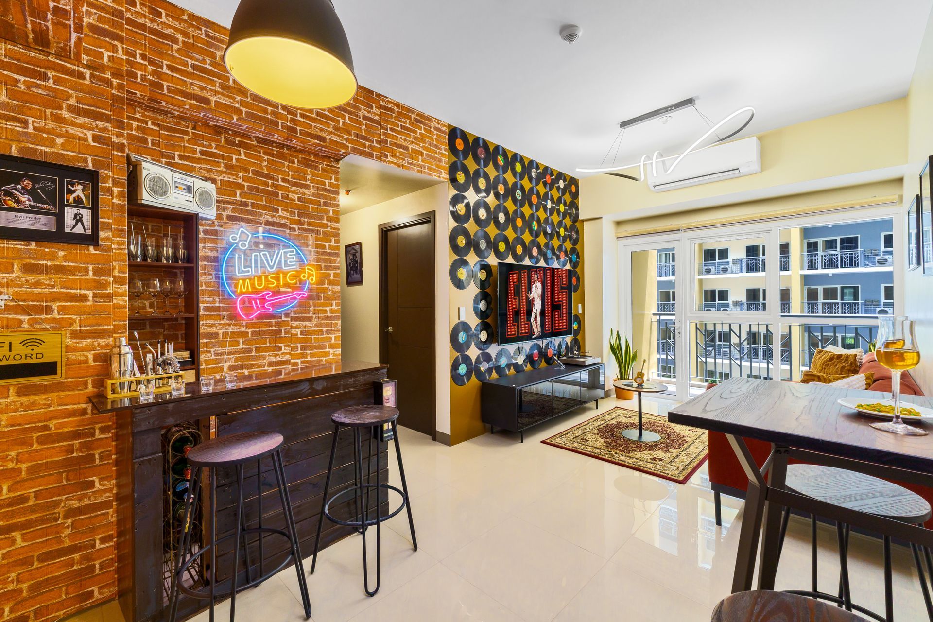 Standup bar area with a faux brick wall behind it and a wall decorated with old vinyl records