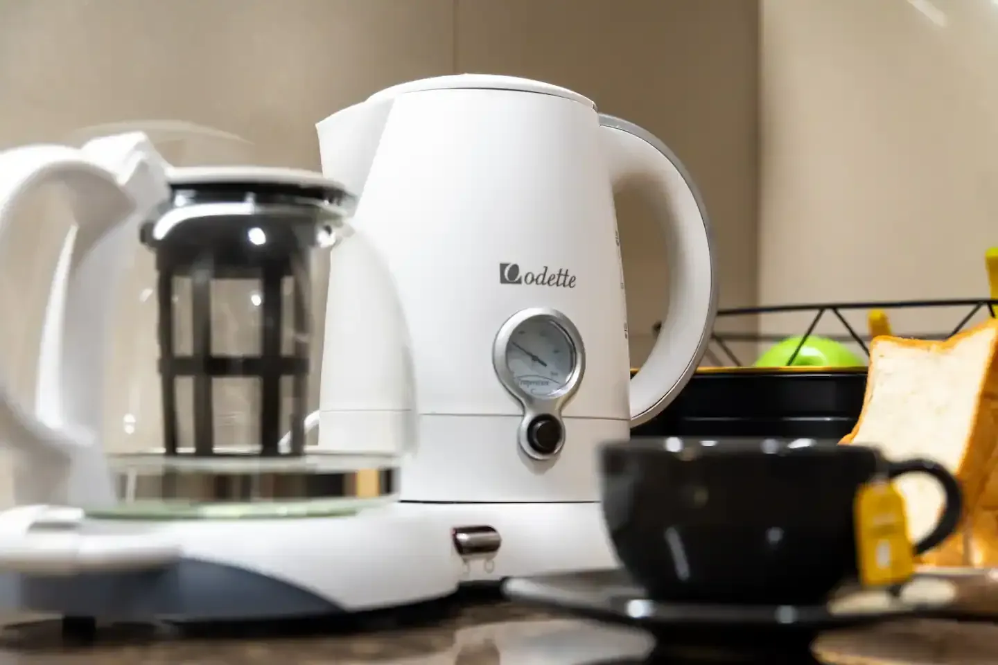 A white kettle and coffee maker are on a counter.  The Den at Bayshore Luxe by Prime, Manila