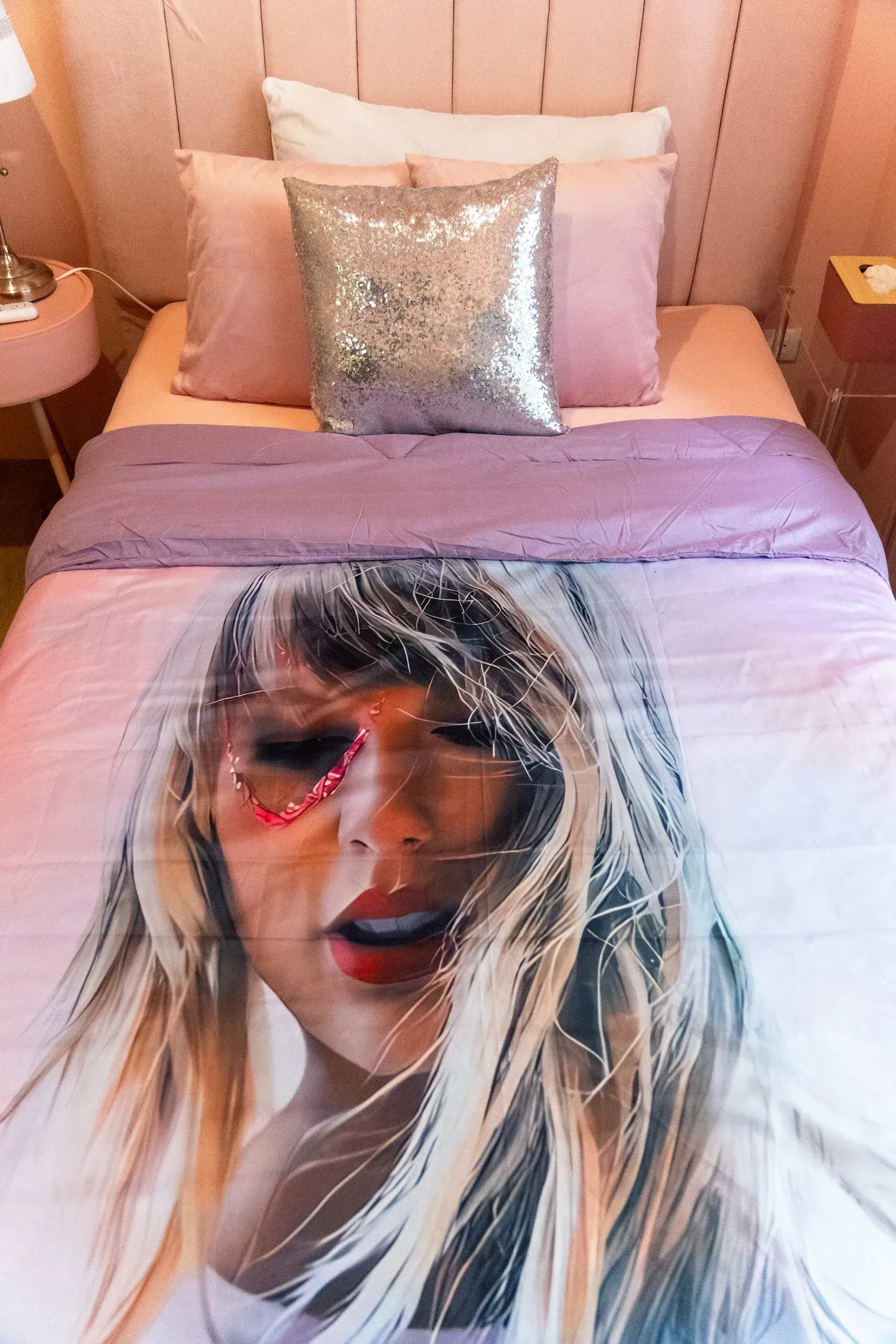 A bed with a Taylor Swift duvet at Bayshore Luxe by Prime, Manila