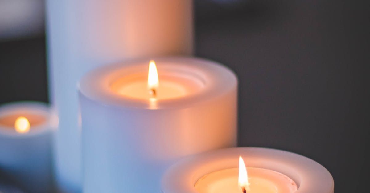 A group of lit candles sitting next to each other on a table.