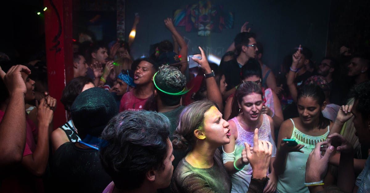 A crowd of people are dancing in a club.