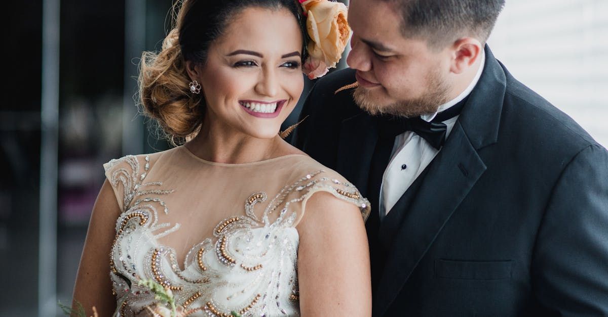 A bride and groom are posing for a picture on their wedding day.