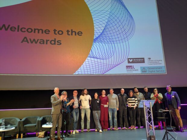 Team Match on stage with the judges after presenting their winning, data-driven prototype for intelligently matching individuals with suitable temporary accommodation. 