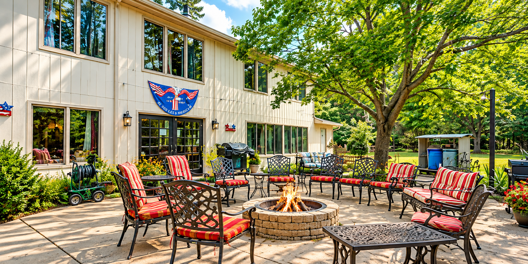 Hidden Haven Adrian Outdoor patio with red chairs and fire pit beside a cream building and trees