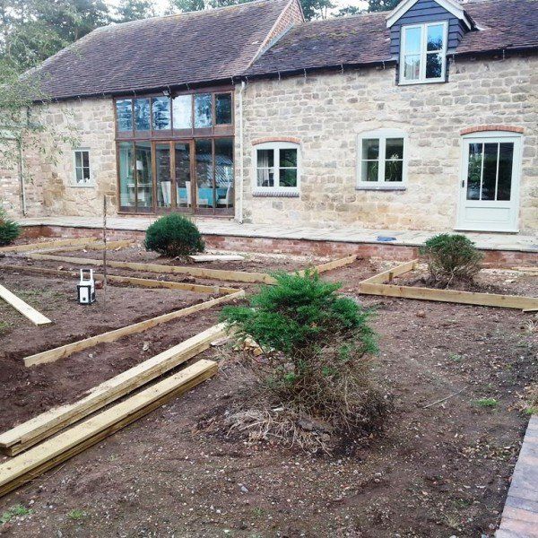 A large stone house with a lot of windows is being built.
