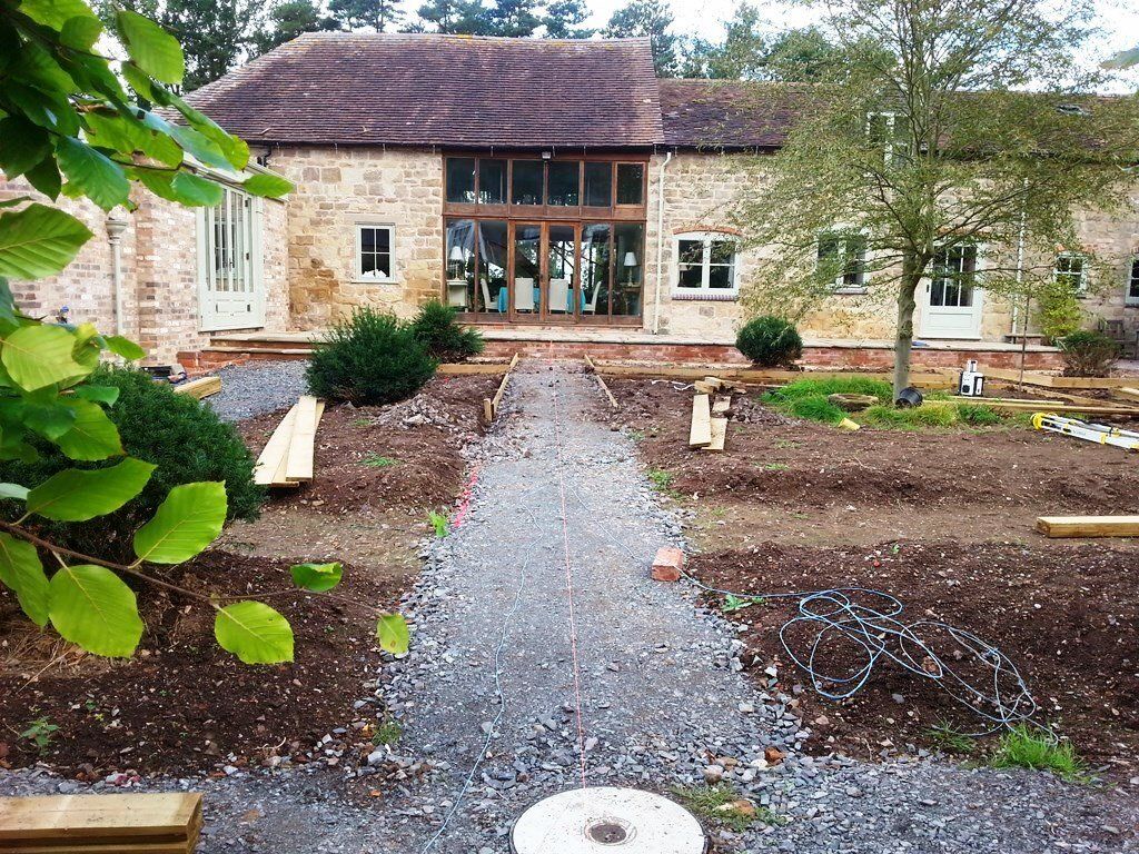 A stone house with a gravel path leading to it.