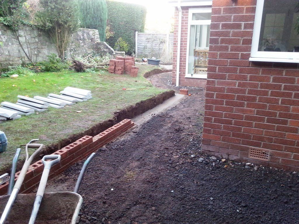 A brick building with a wheelbarrow in front of it