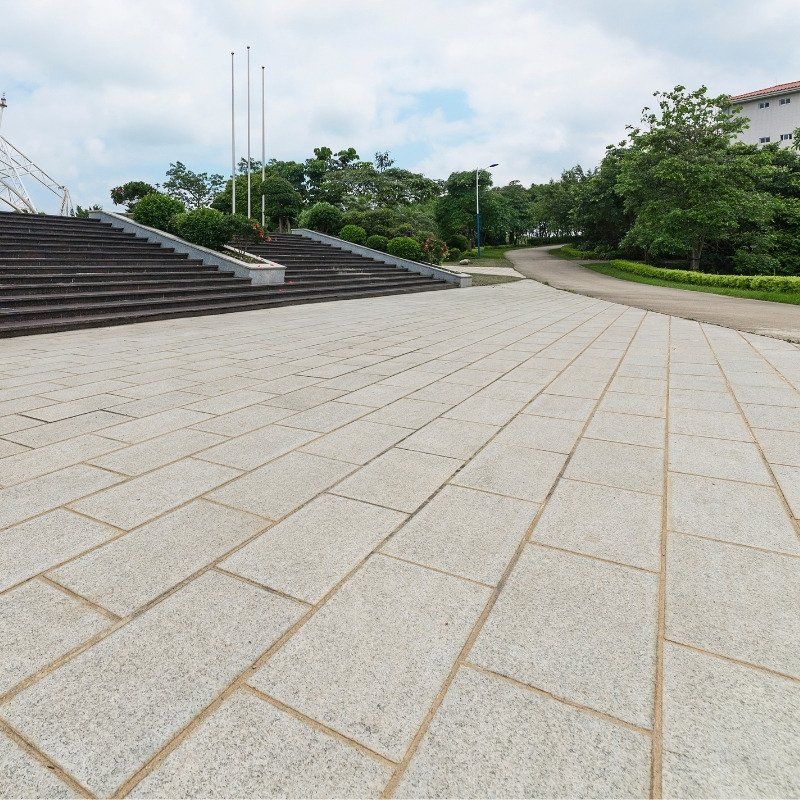 An empty brick walkway with stairs in the background