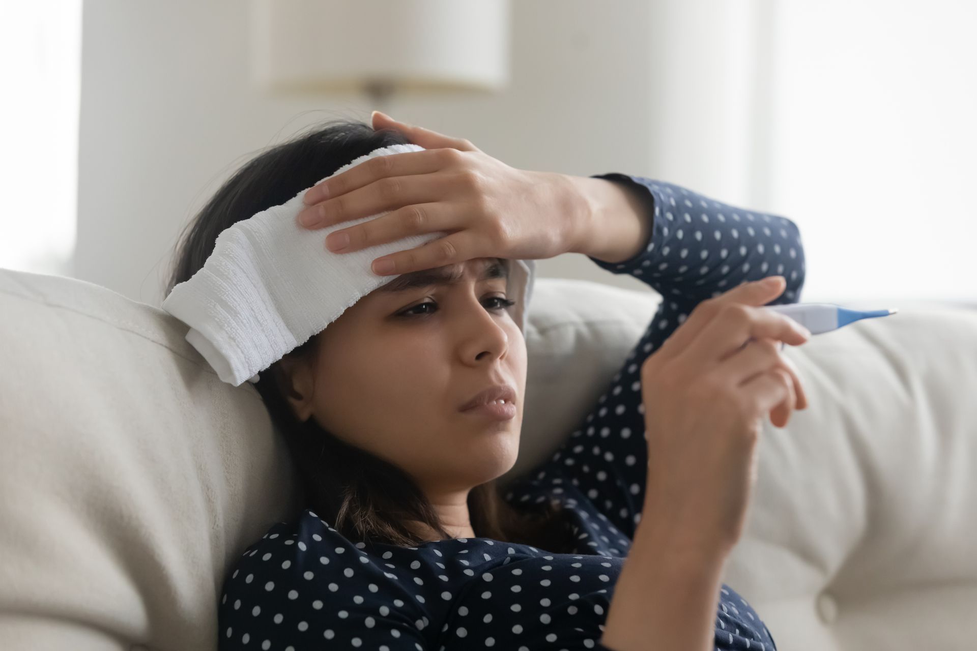 sick teen girl at home with a fever