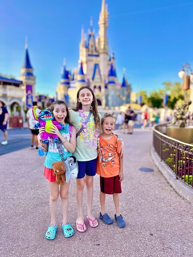 The kids of The McFive Circus pose in front of Cinderella's Castle in Magic Kingdom