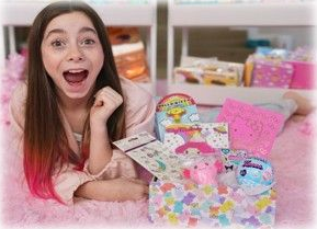 Girl smiling beside colorful toy and gift boxes in a pink bedroom