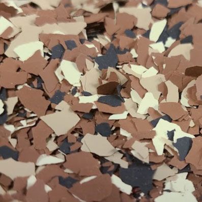 Close-up of brown, beige, white, and dark blue floor flakes.
