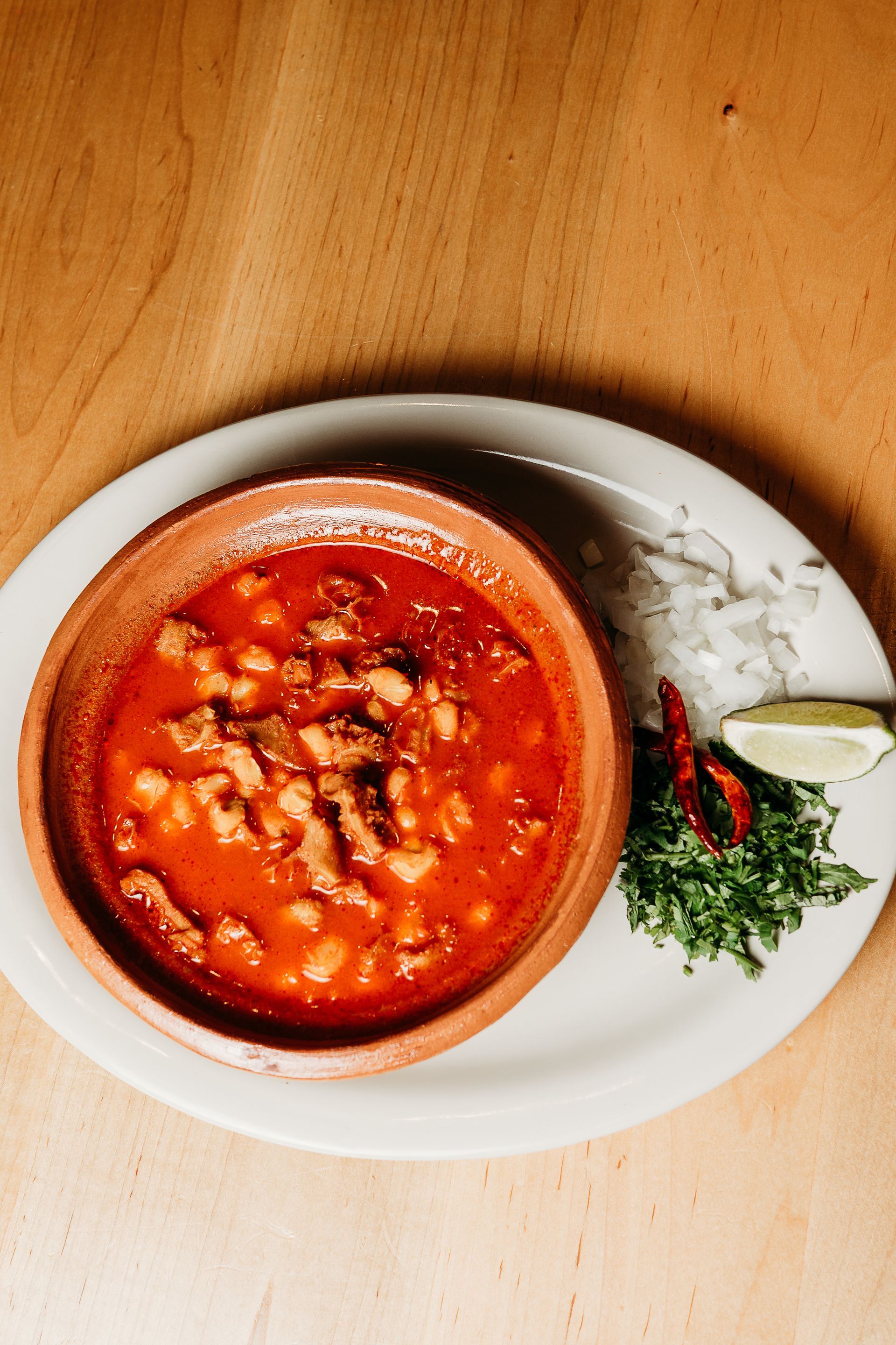 There are many different types of tacos and salsas on the table.