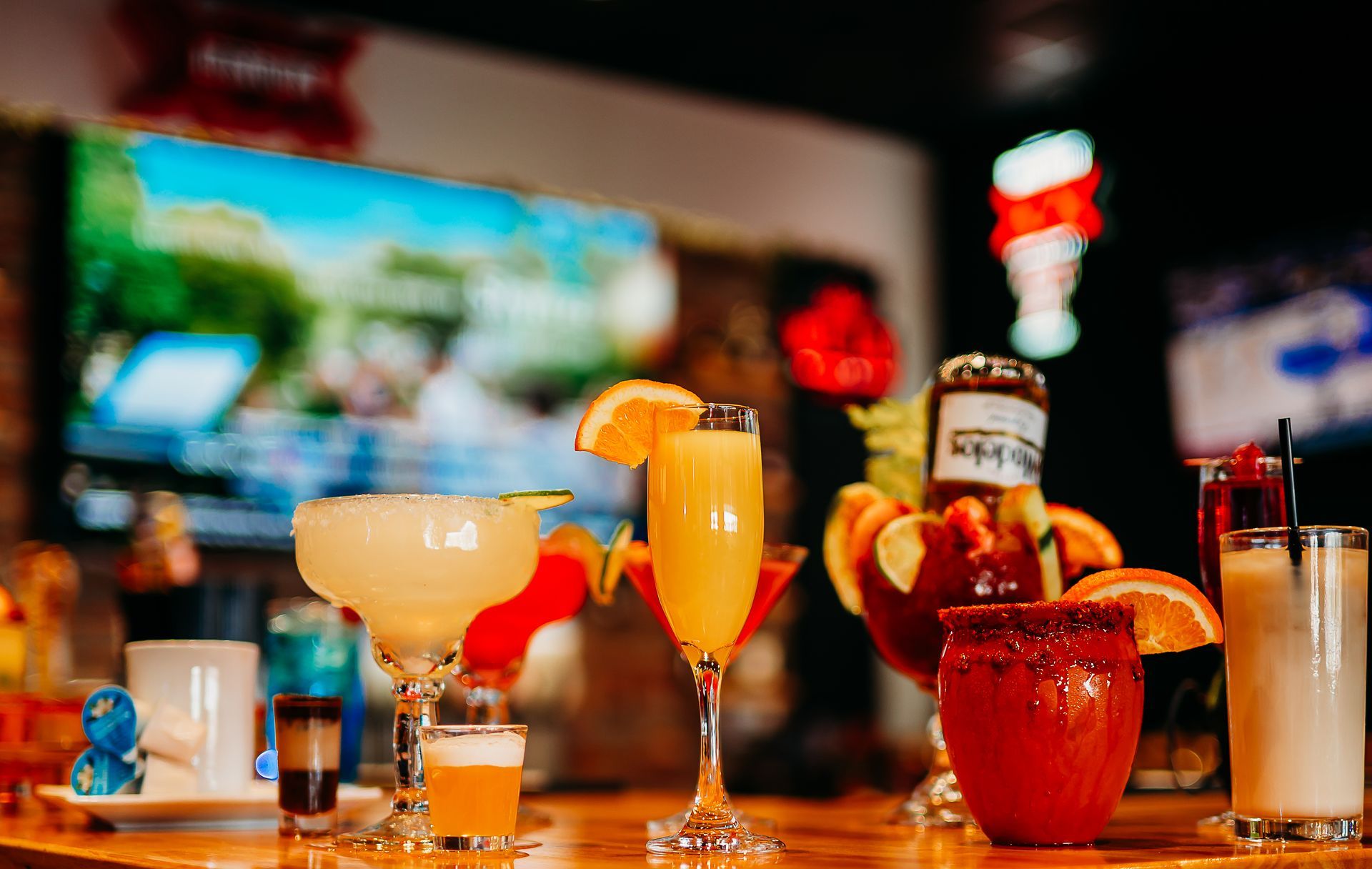 There are many different types of cocktails on the table.