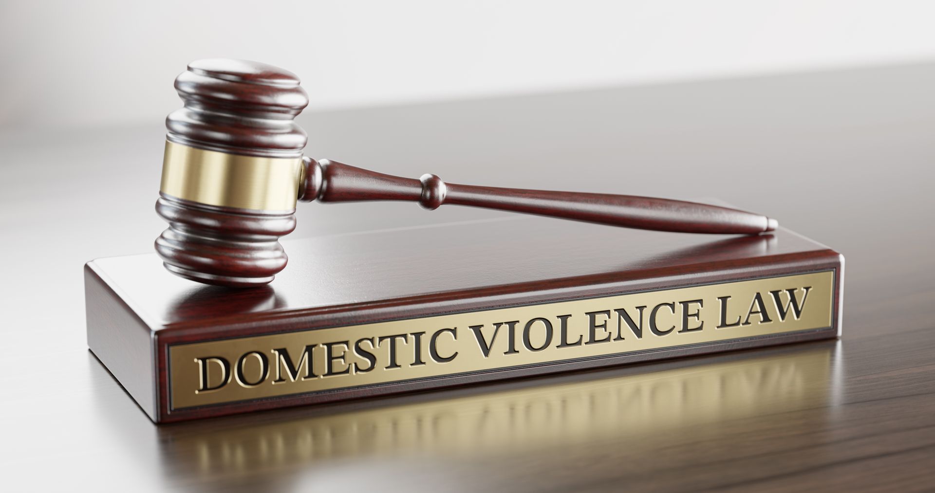 Judge's gavel and wooden stand with text word “Domestic violence law