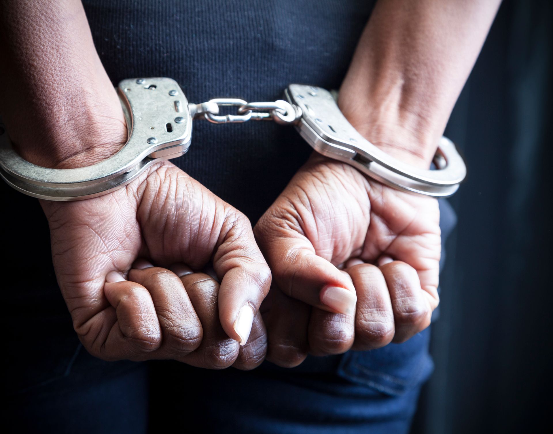 A person is wearing handcuffs on their hands.