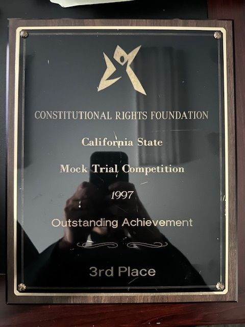 Plaque from 1997 California Mock Trial Competition, 3rd place, held by Constitutional Rights Foundation. Dark wood border.