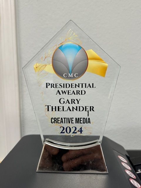 Glass award for Gary Thelander, Presidential Award in Creative Media, 2024.