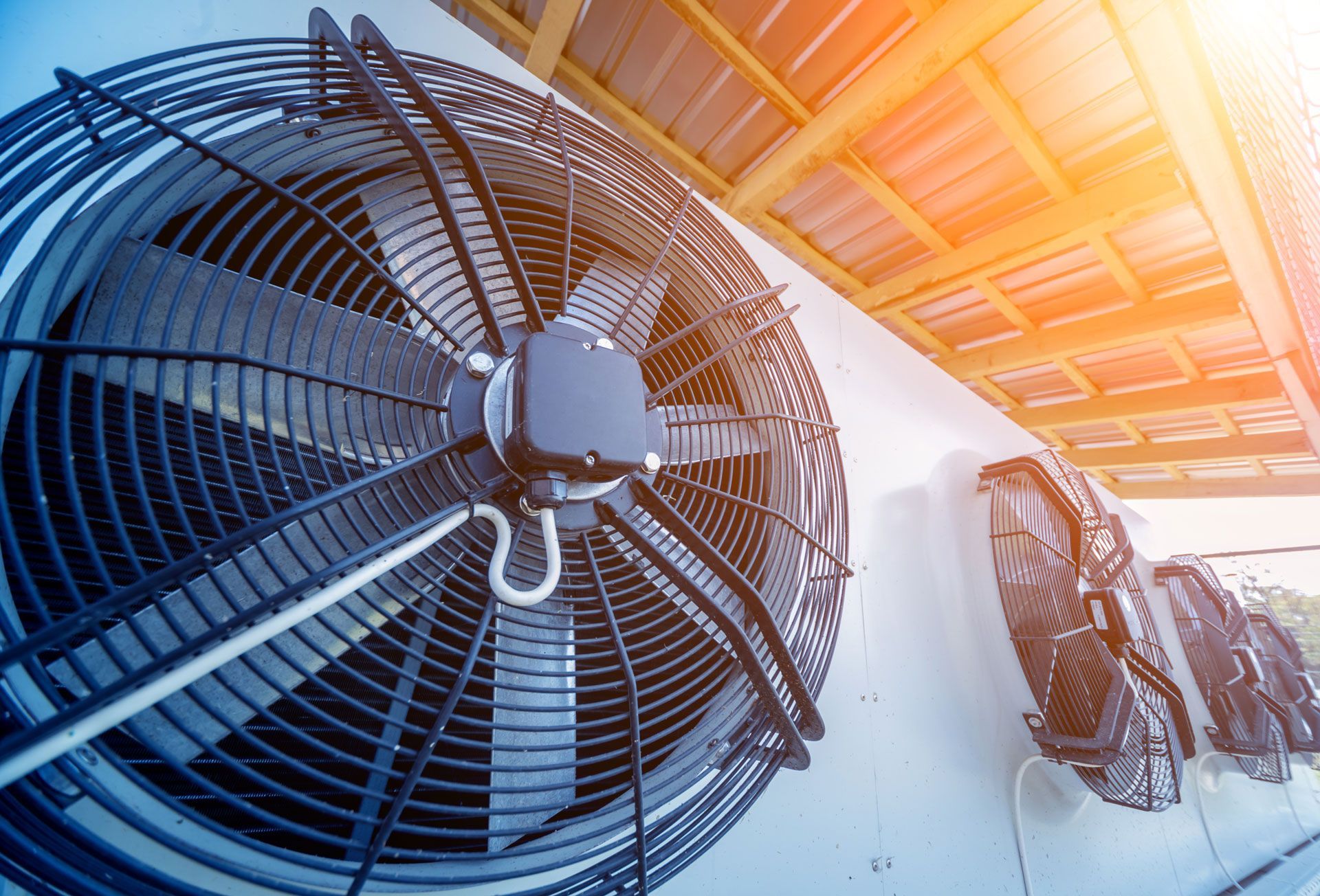A large fan is hanging from the ceiling of a building.