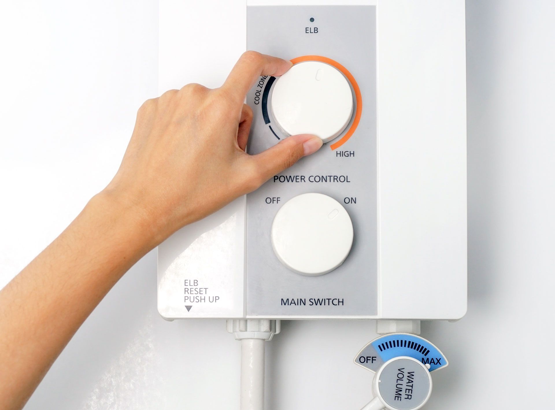 A person is adjusting the temperature of a water heater.