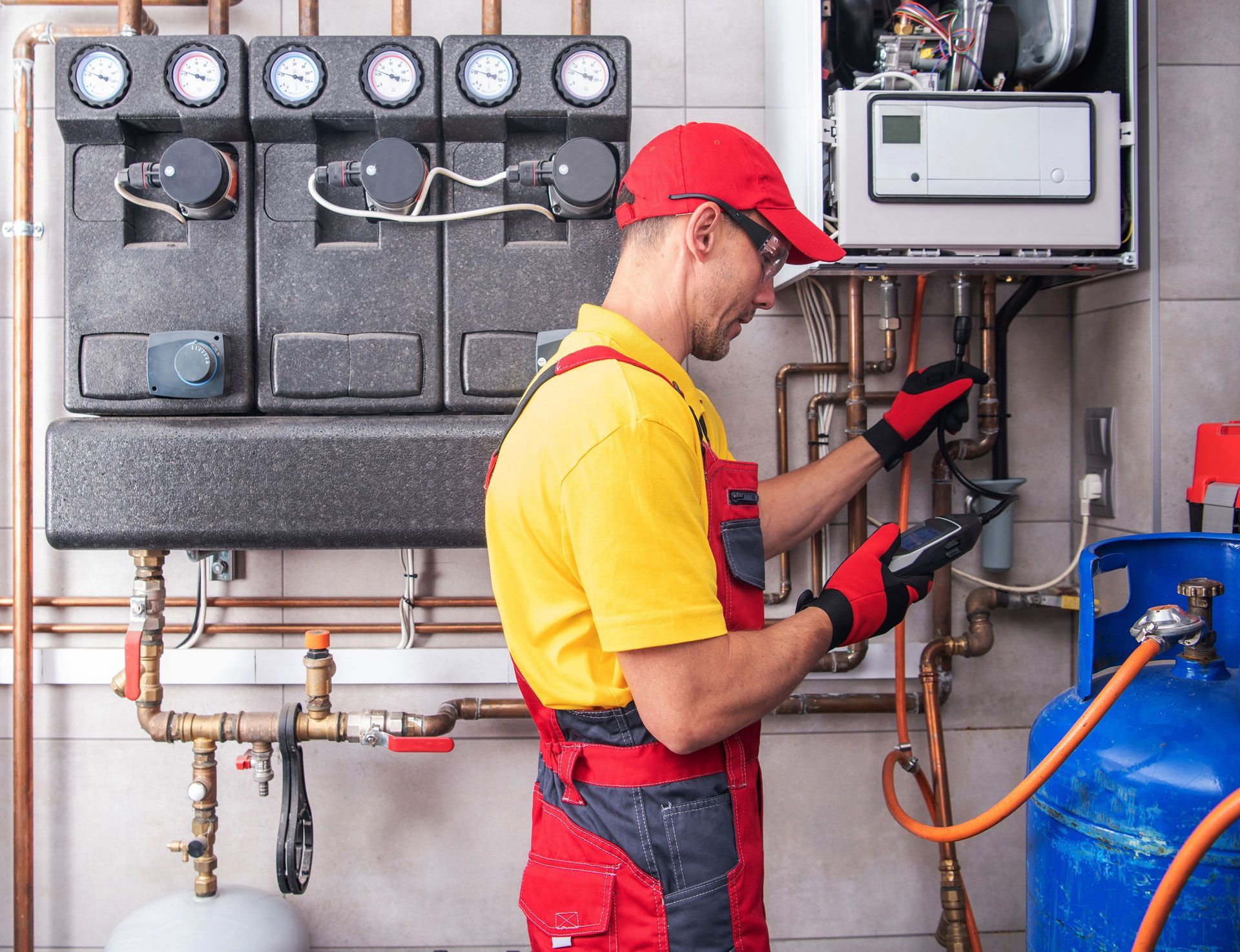 A man is working on a heating system in a room.