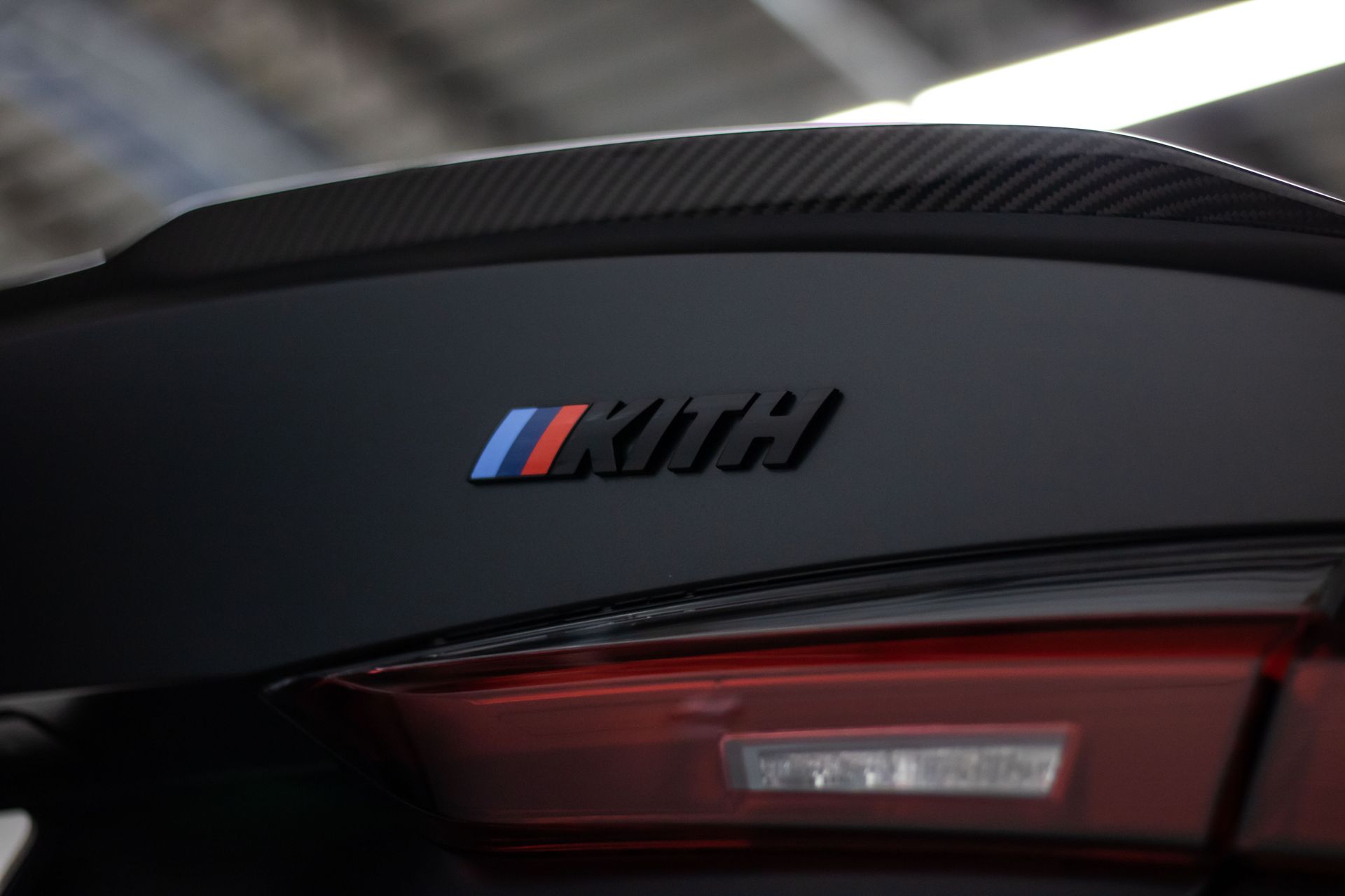 A close up of the rear wing of a black bmw.