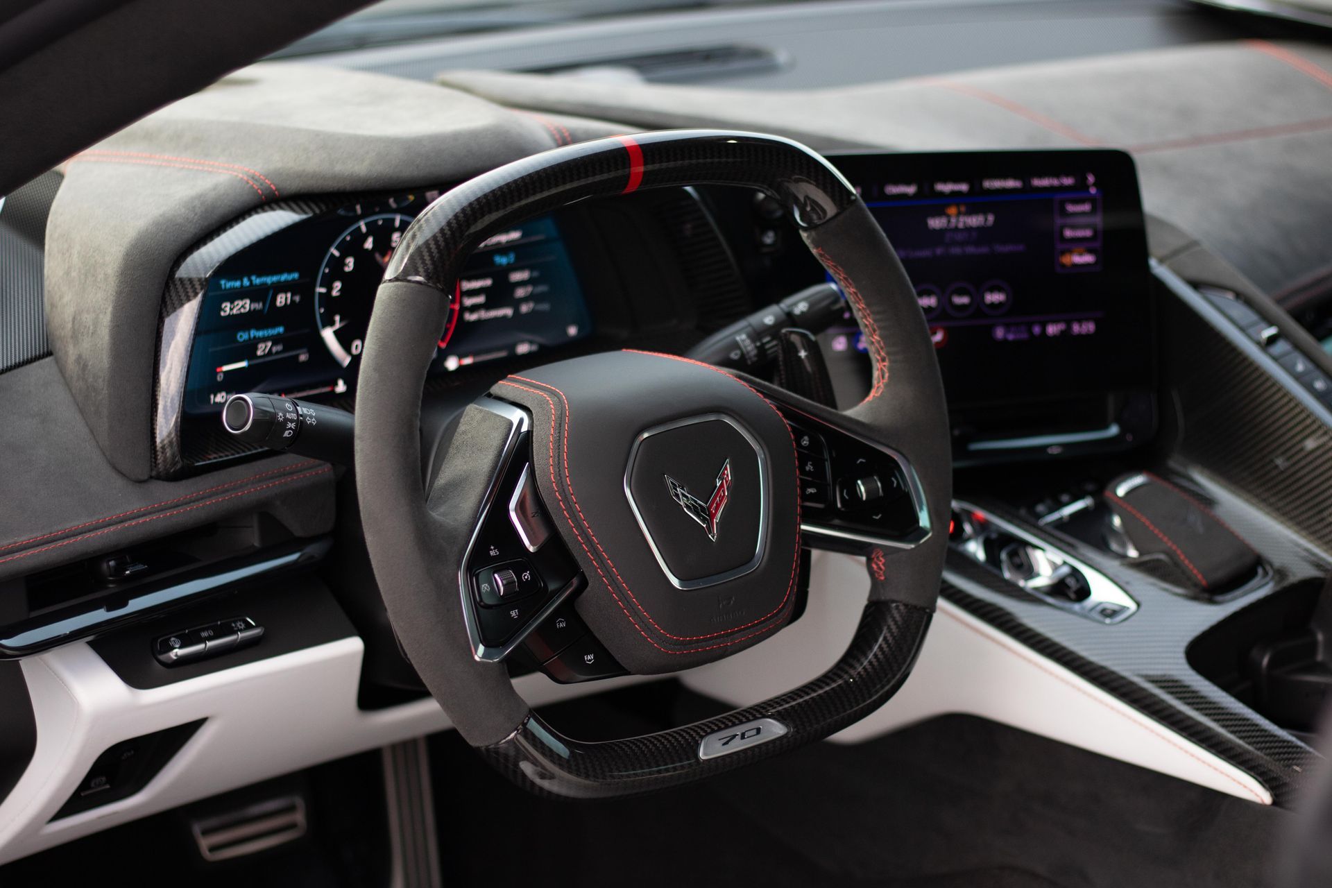 A close up of the steering wheel and dashboard of a car.