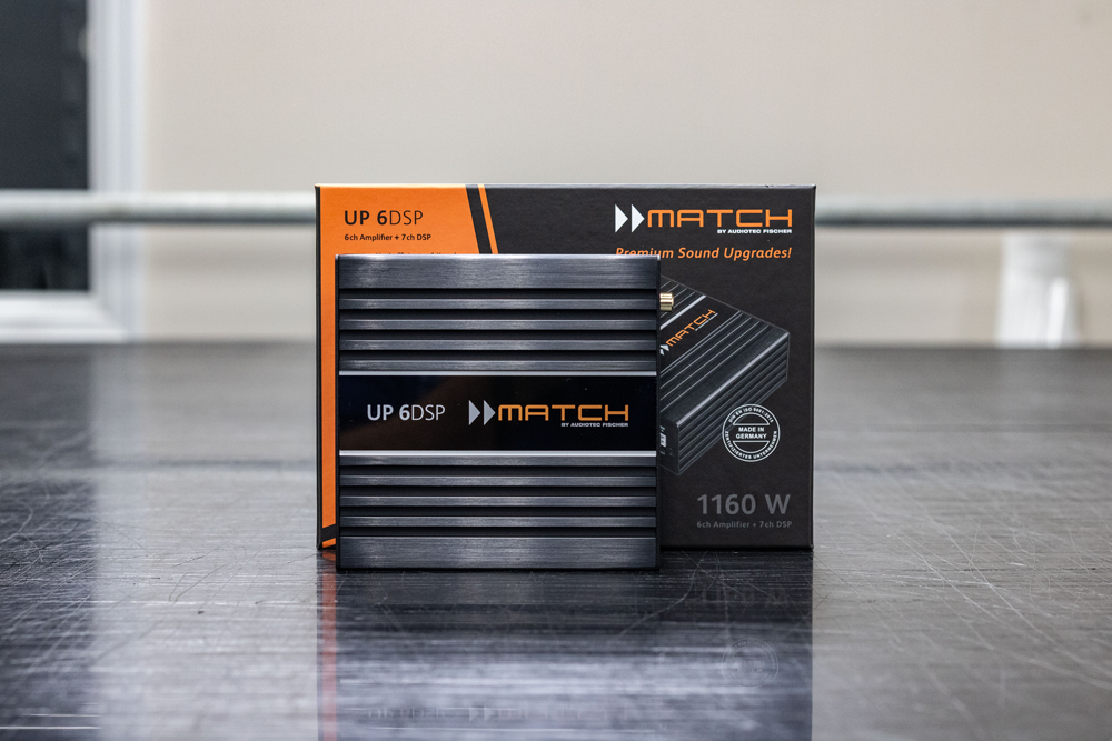 MATCH 1160W power supply box and unit, black with orange accents, on a tabletop