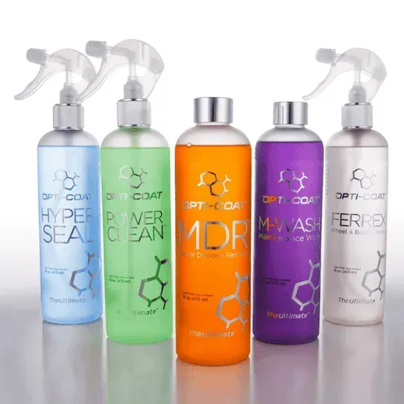Five bottles of different types of spray cleaners are lined up in a row