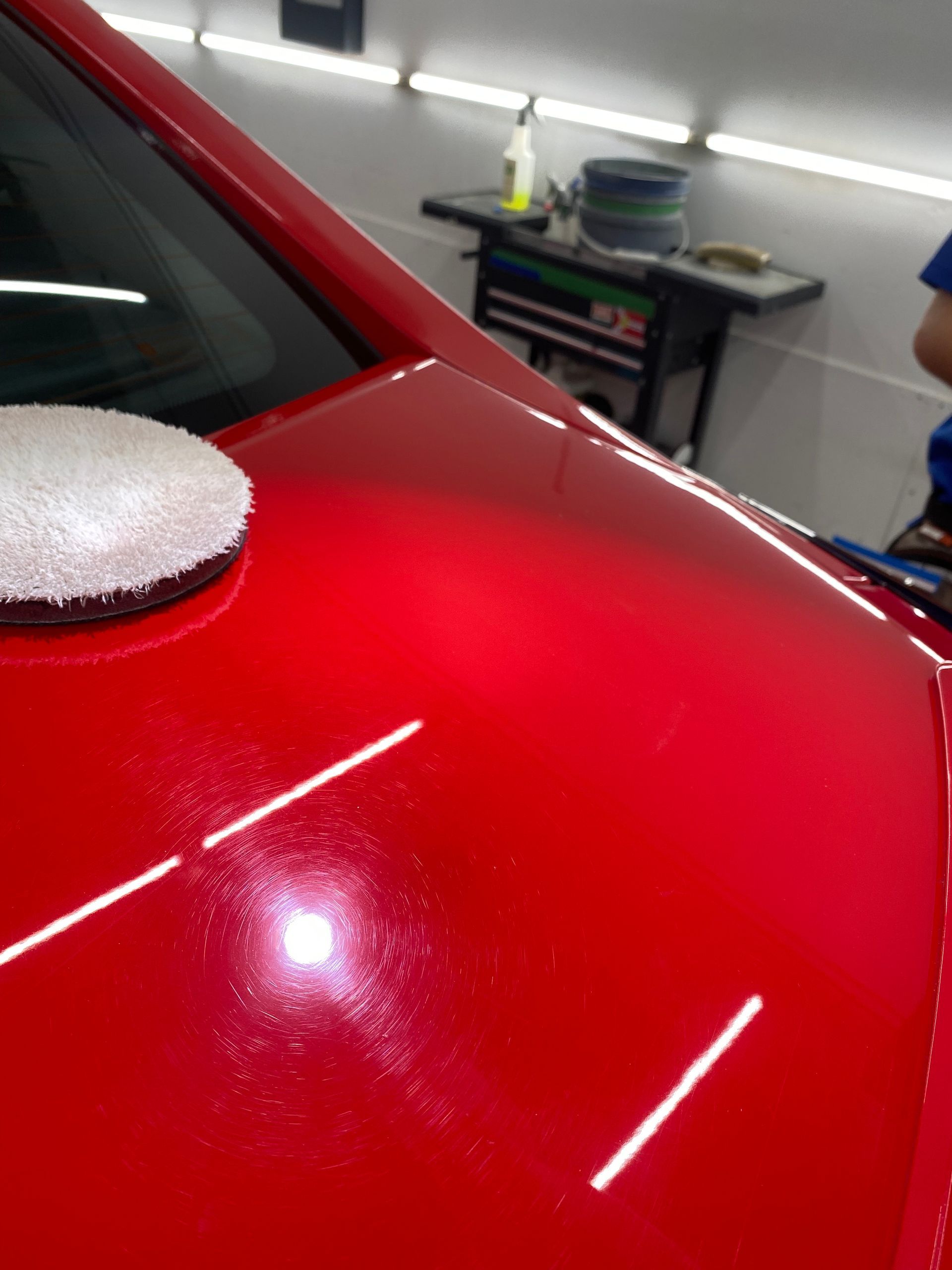 A red car with a sponge on top of it