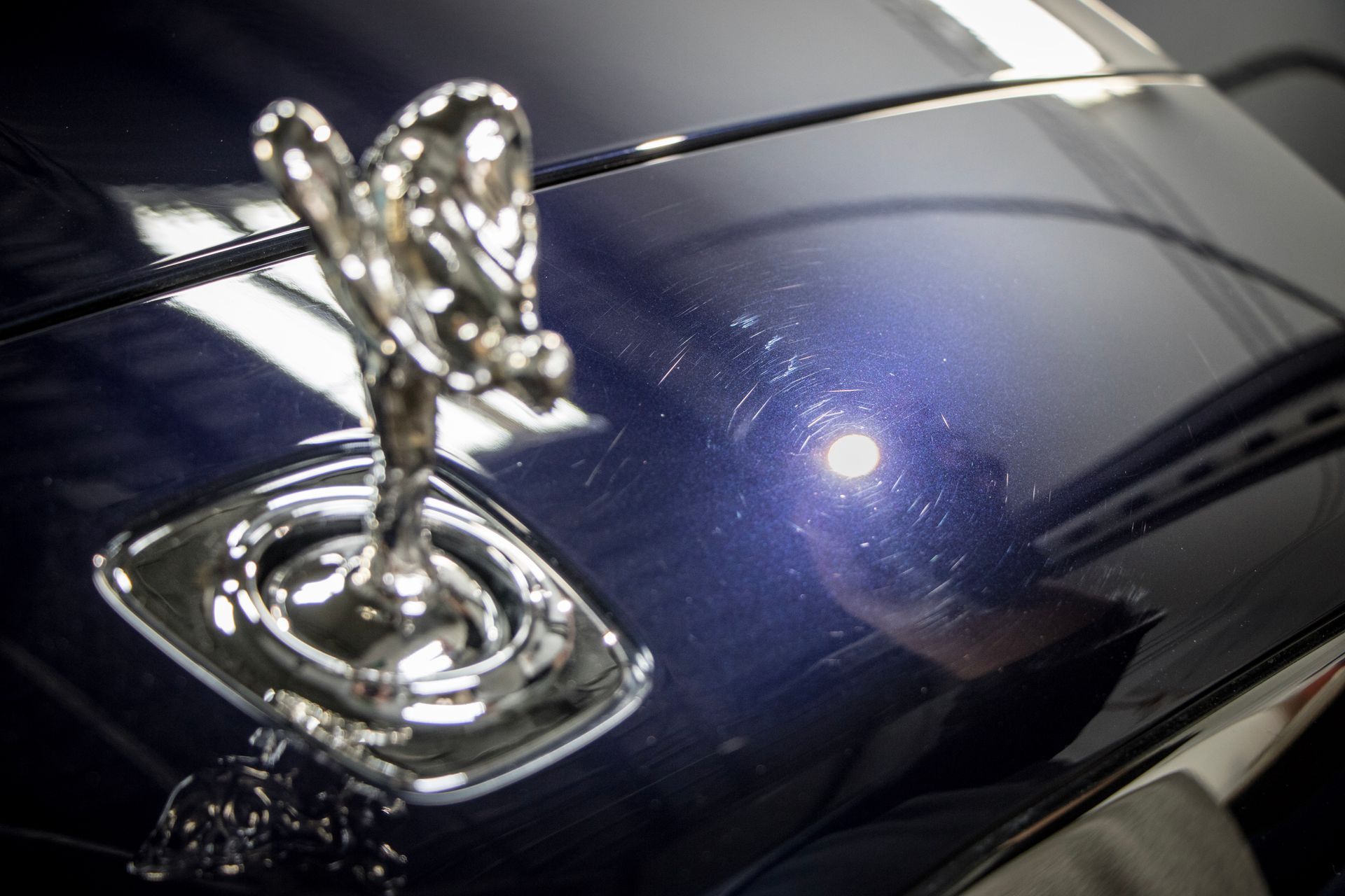 A close up of the hood of a rolls royce car
