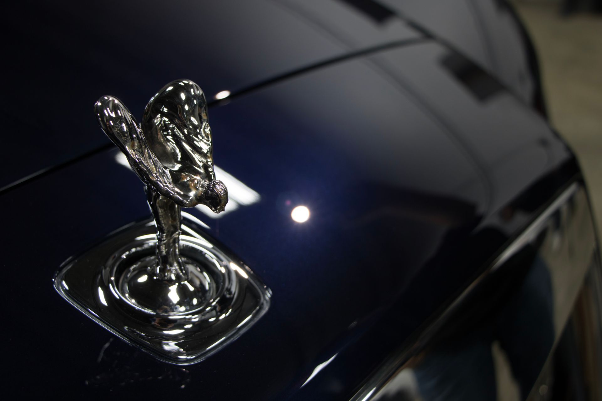 A close up of a hood ornament on a car