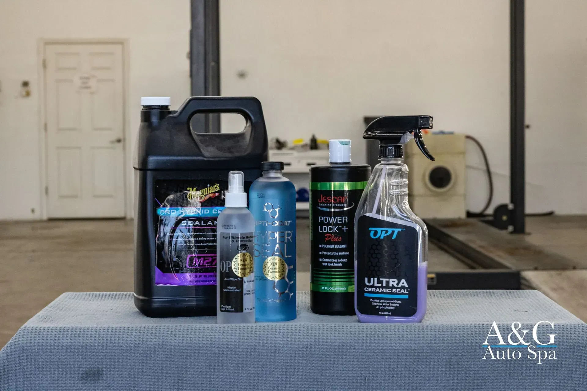 A group of bottles sitting on top of a table in a garage.