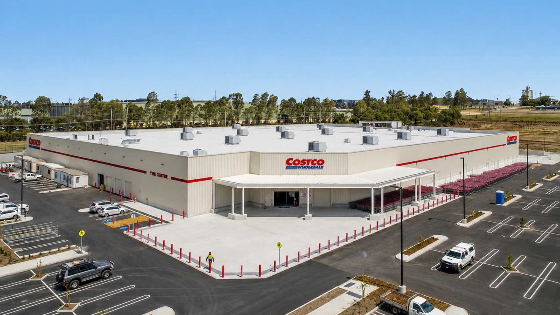 Aerial view of a large Costco warehouse store with parking lot and scattered cars