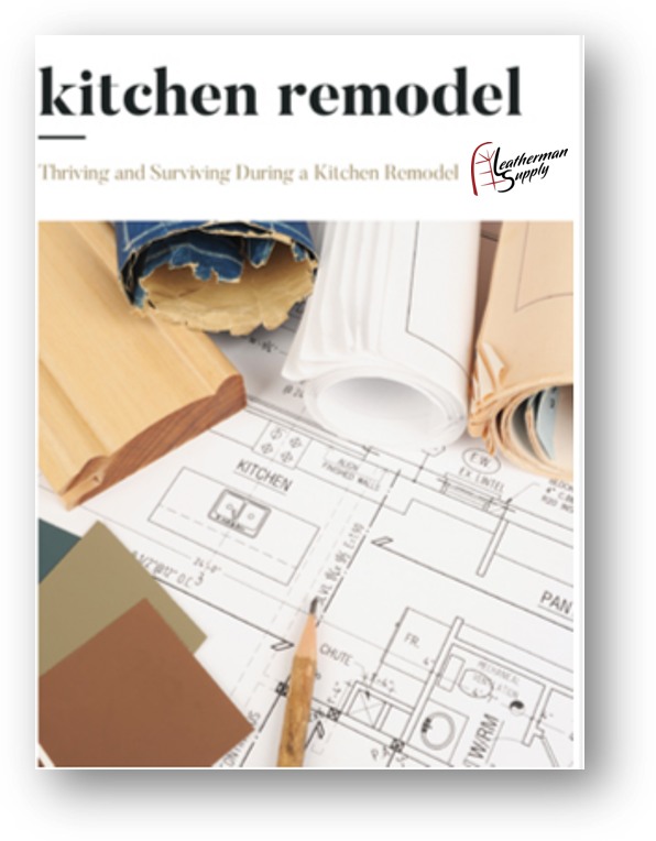 Kitchen remodel booklet cover with floor plans, paint swatches, and a white lamp on blueprints