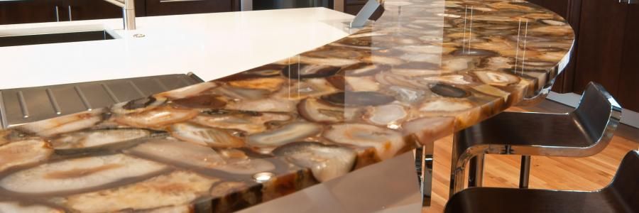 Glossy amber-and-black marbled countertop with curved edge in a modern interior