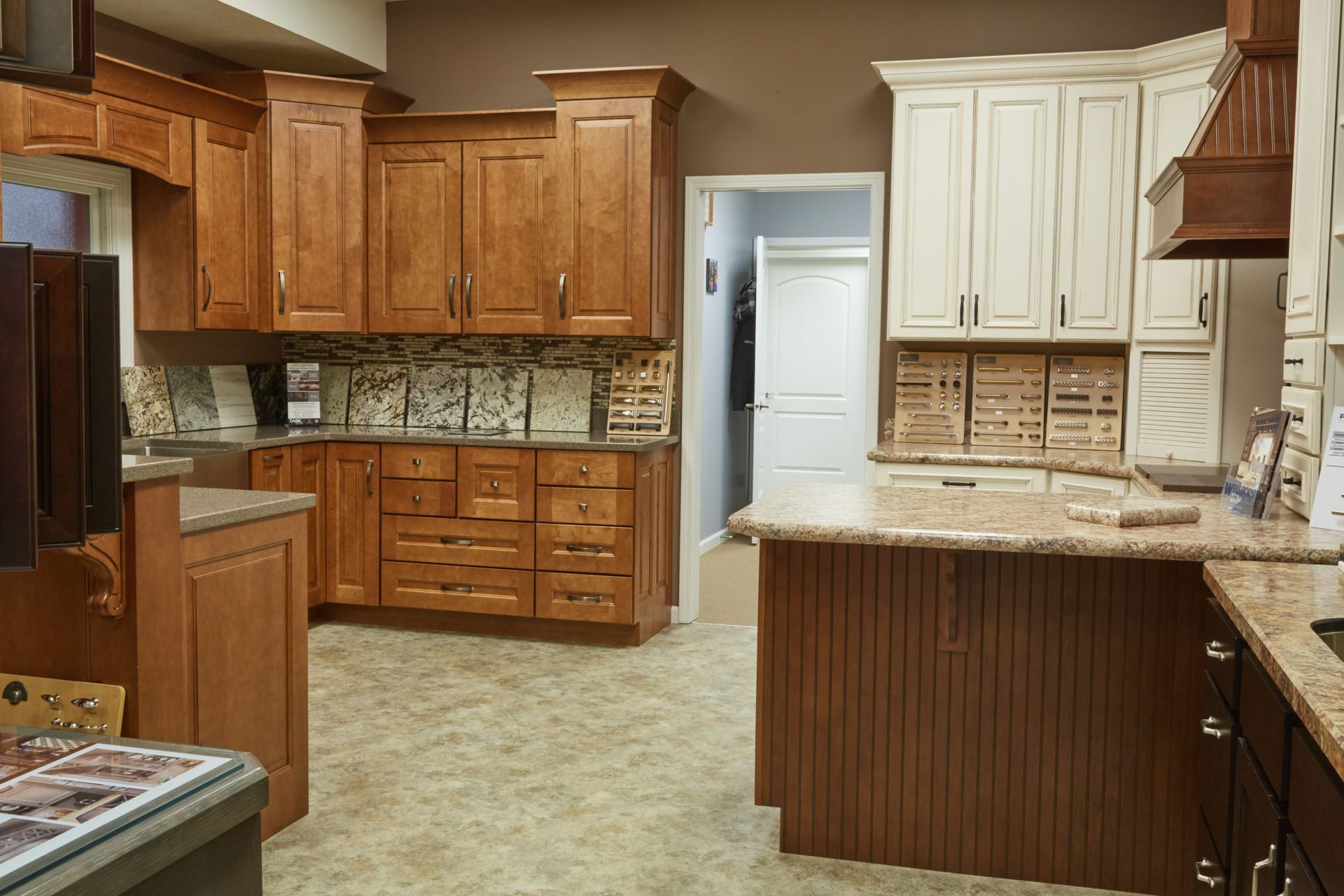 Spacious kitchen with wood and cream cabinets, granite counters, and tiled backsplash.