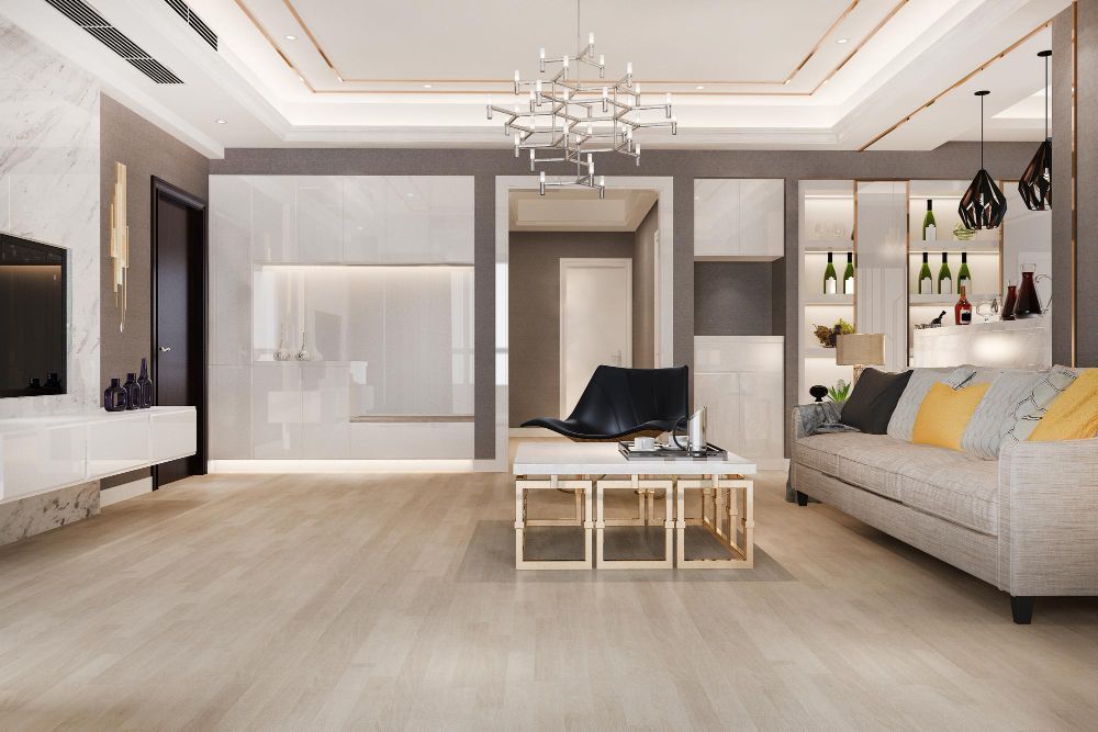 Modern living room with light wooden floors, built-ins, gray walls, and stylish furniture.