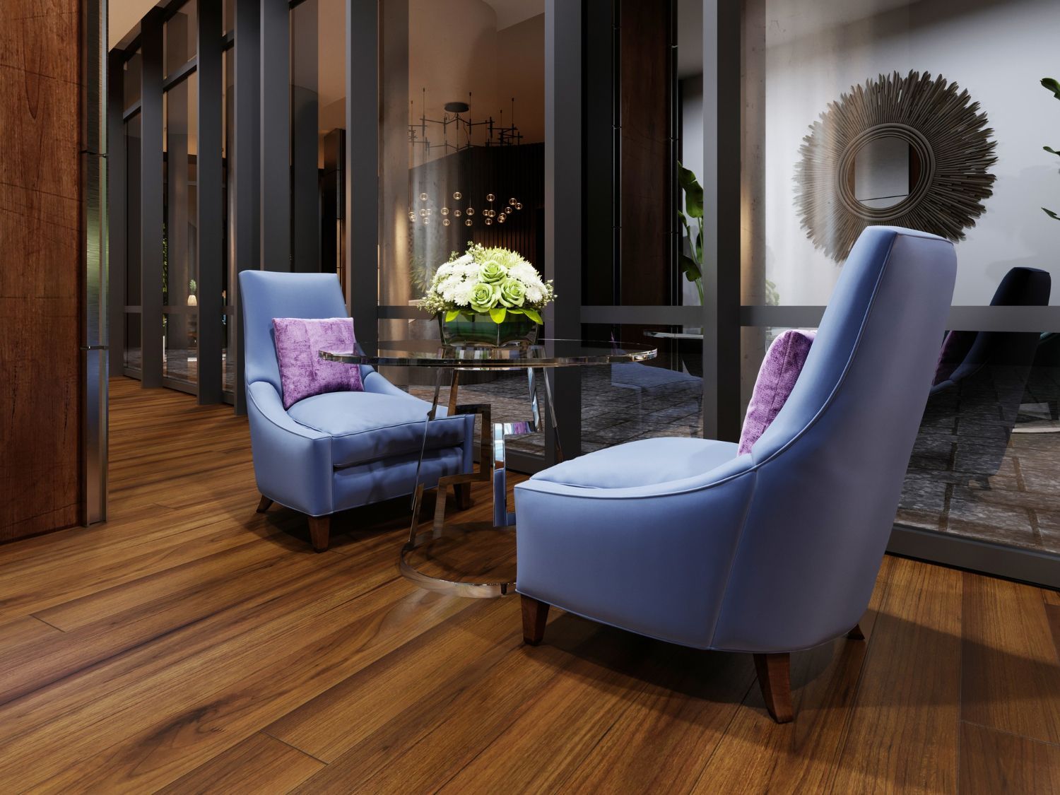 Two blue armchairs with purple pillows and a small glass table.