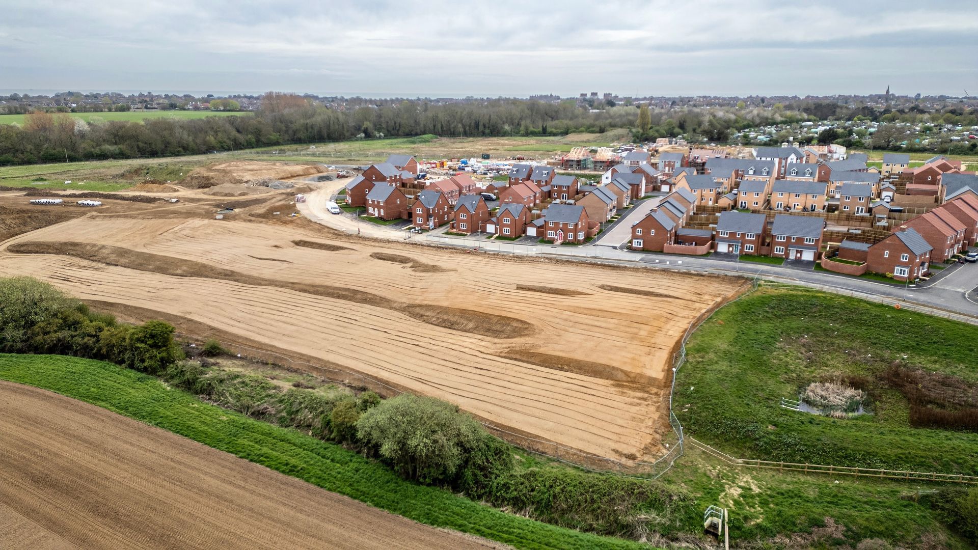 An aerial view of a residential area under construction in the countryside.