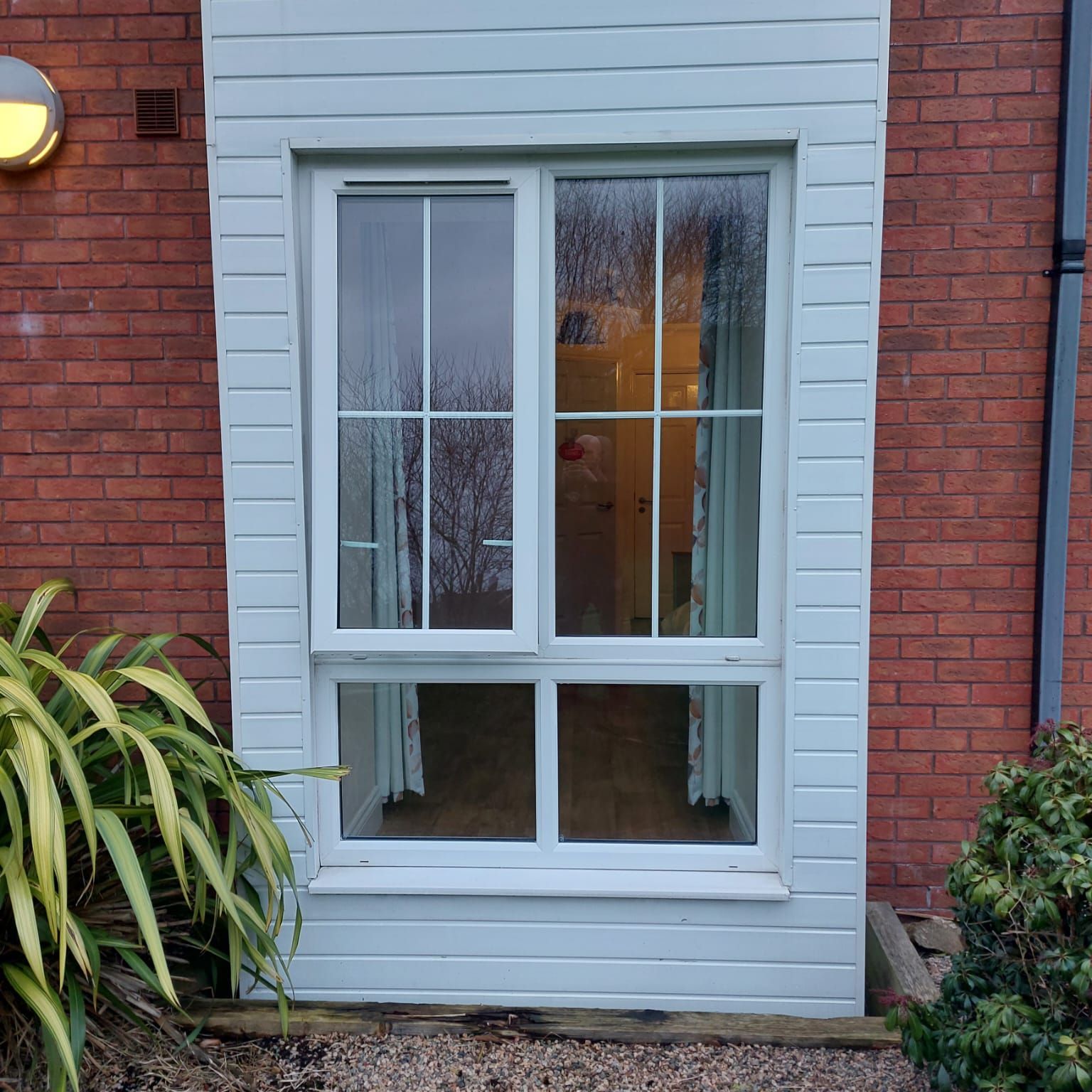 A white window on a red brick building