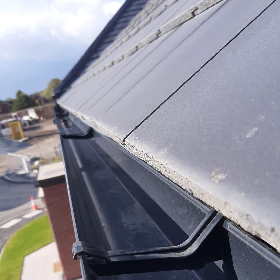 A close up of a gutter on a roof