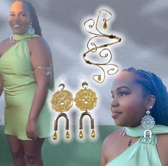 Woman in green dress, jewelry. Gold arm cuff and earrings.