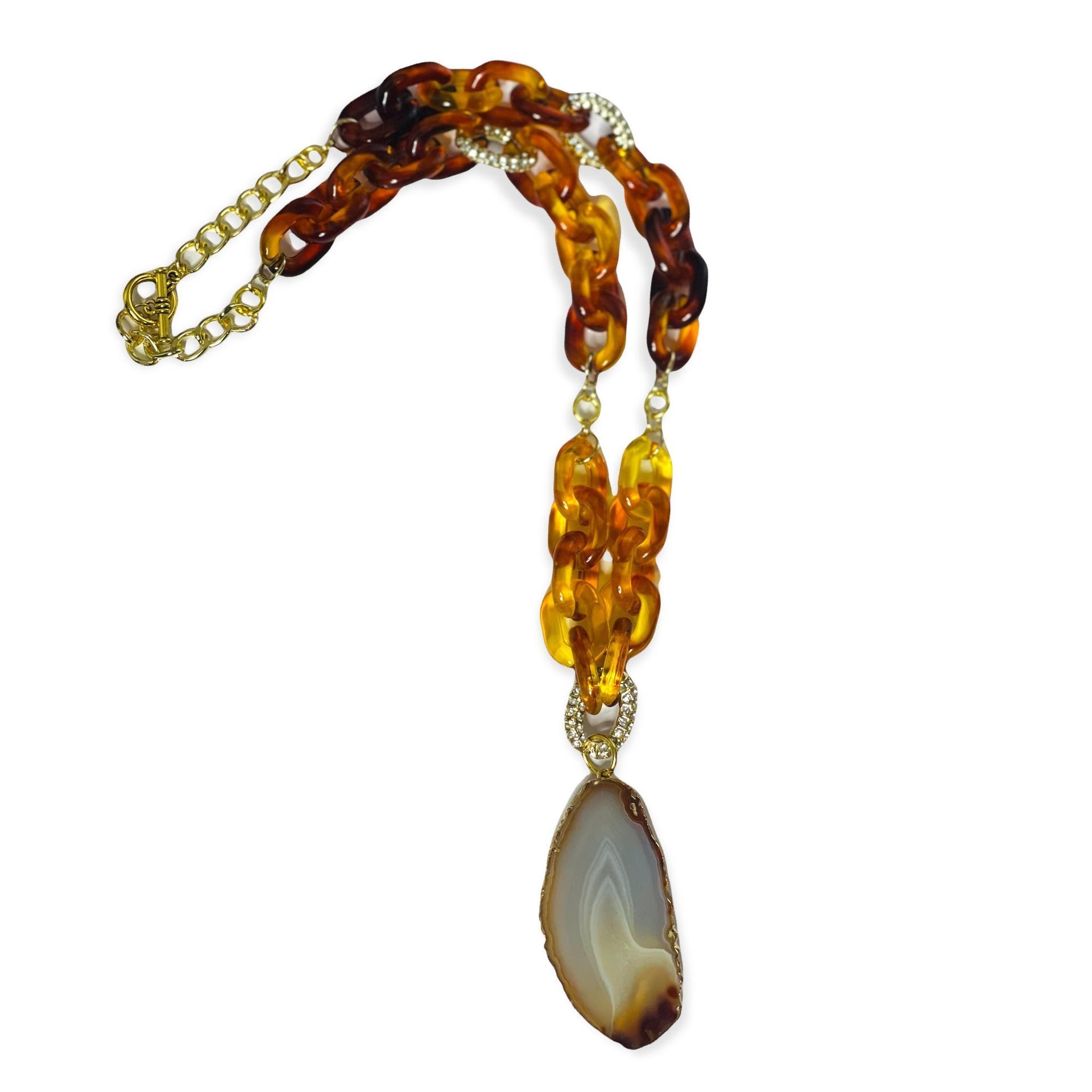 Brown, amber, and gold necklace with stone pendant.