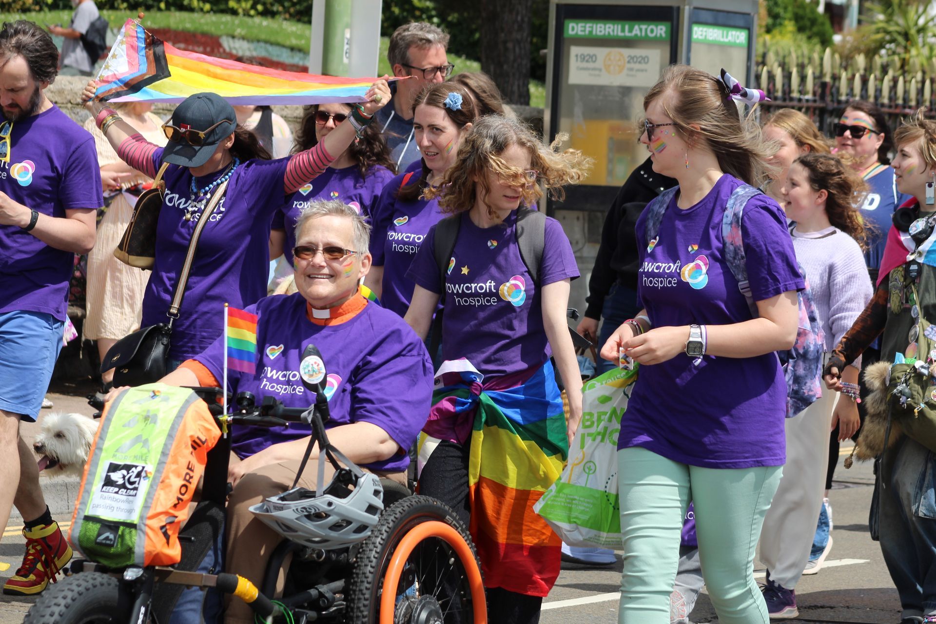 A number of rowcroft people in purple walling in a pride march 