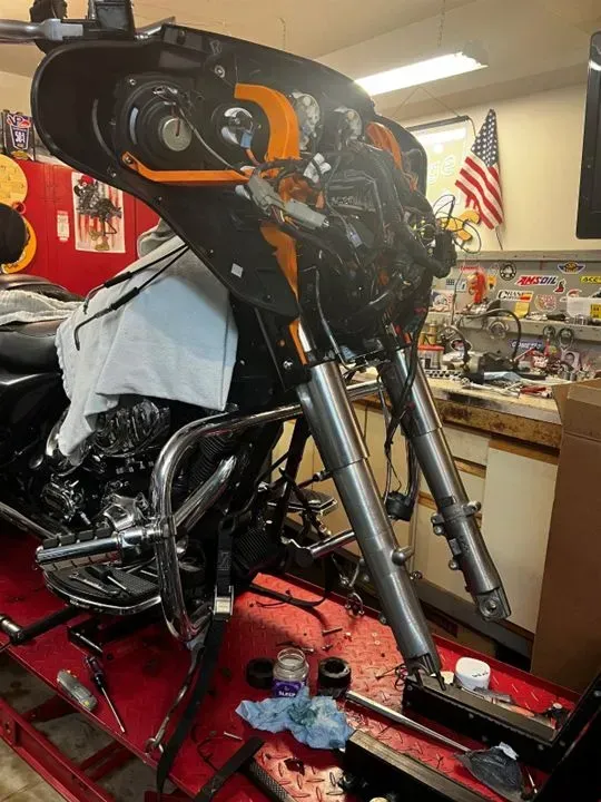 A harley davidson motorcycle is being worked on in a garage